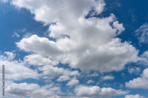 Fluffy White Clouds With Hints of Grey Against Bright Blue Sky