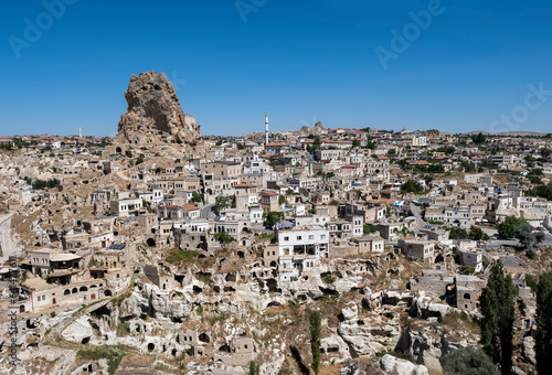 Ortahisar, typical village carved in rock and stone with the castle of Ortahisar on a large volcanic rock that crowns the village, Cappadocia, Anatolia, Turkey