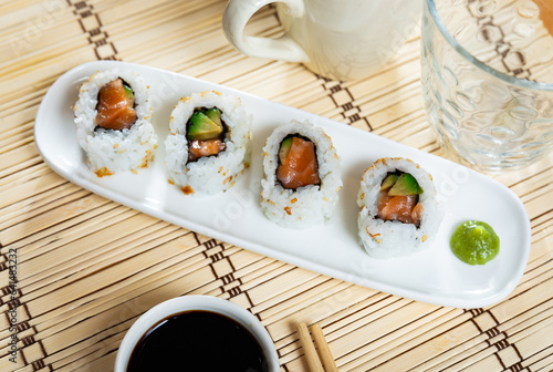 Japanese roll california urumaki with salmon avocado and sesame photo