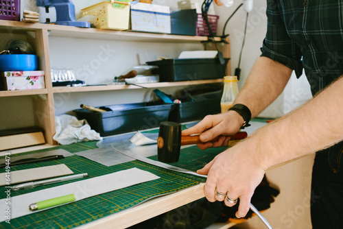 Leather craftsman using mallet