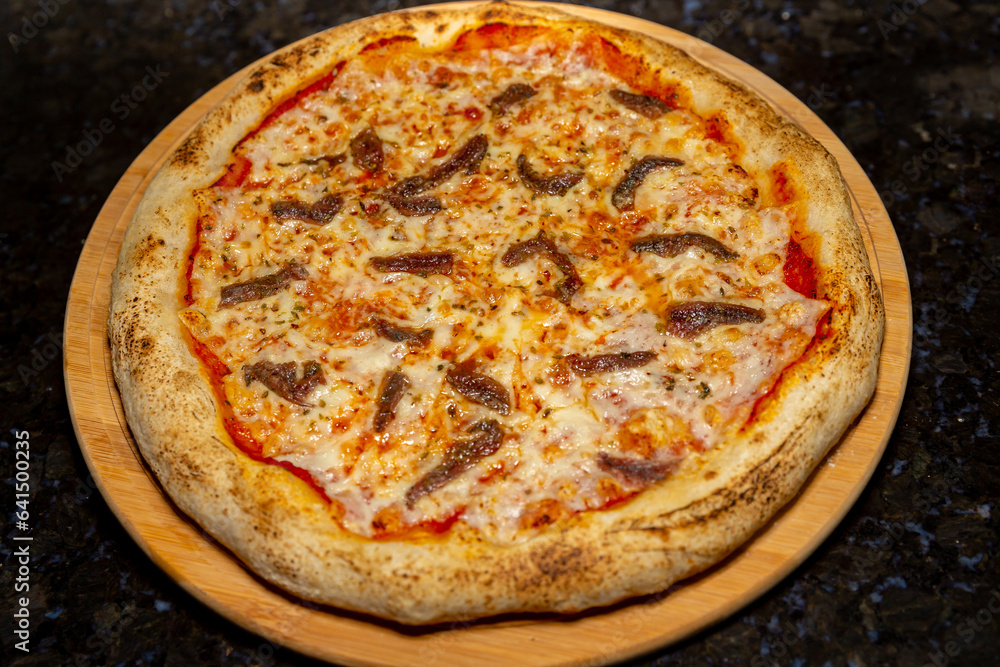 Traditional anchovy pizza (alicci) with artisan long-matured dough. Traditional anchovy pizza (alicci) with artisan long-matured dough.