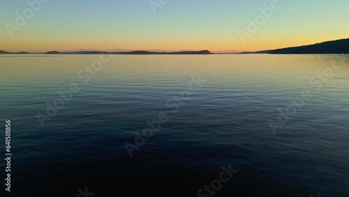 Aerial shot of the Pacific Ocean in Orcas Island, Washington during a summer day in the Pacific Northwest during sunset