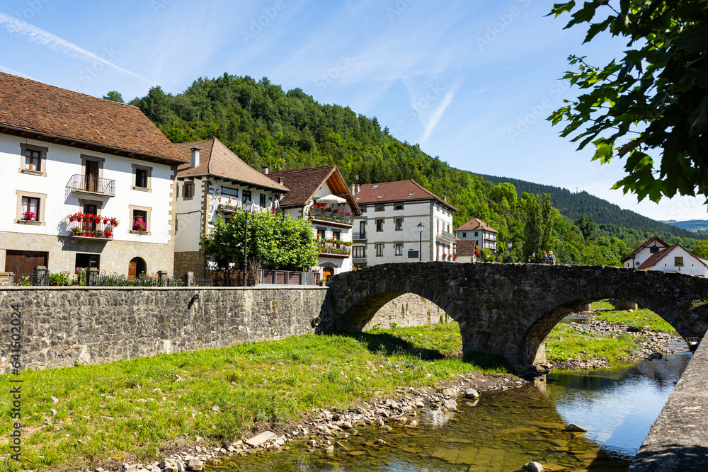 Picturesque village of Ochagavia with beautiful houses, stone bridge and natural environment near the Pyrenees in Spain