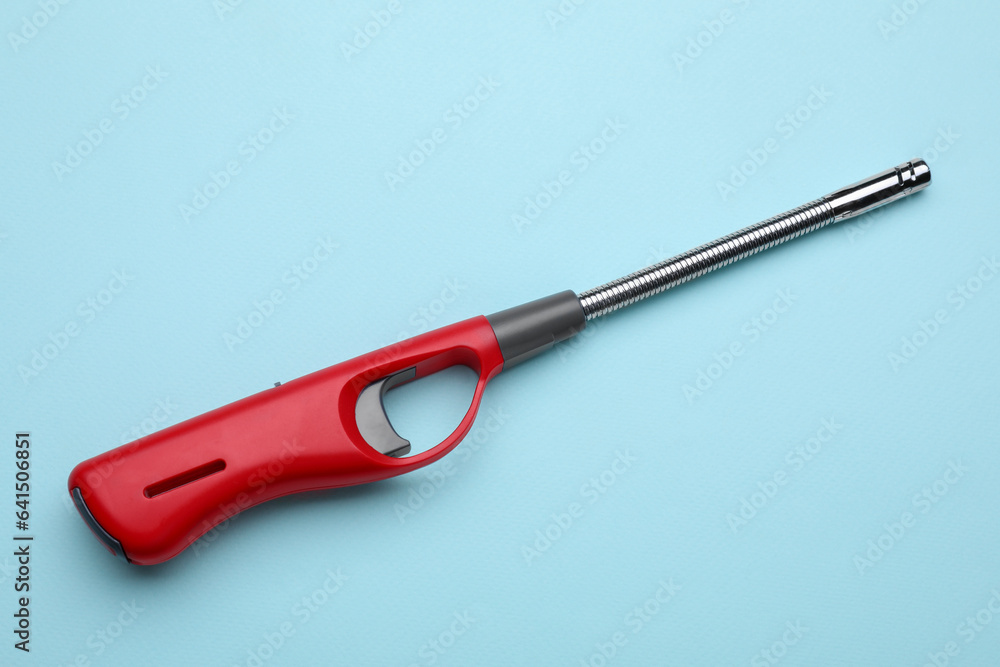One gas lighter on light blue background One gas lighter on light blue background