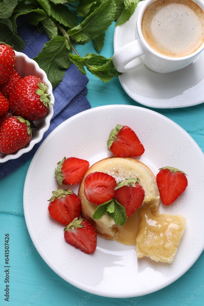 Tasty vanilla fondant with white chocolate, strawberries and cup of coffee on light blue wooden table, flat lay Tasty vanilla fondant with white chocolate, strawberries and cup of coffee on light blue wooden table, flat lay