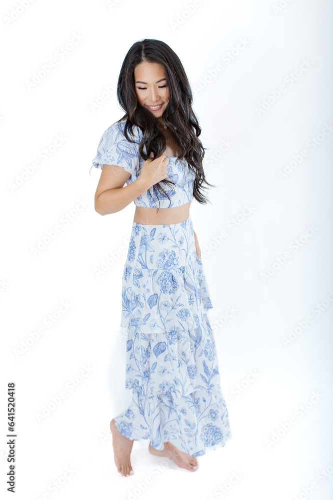 Asian young woman in summer dress against white background Asian young woman in summer dress against white background