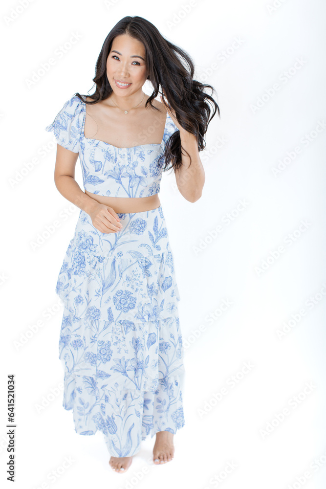 Asian young woman in summer dress against white background Asian young woman in summer dress against white background