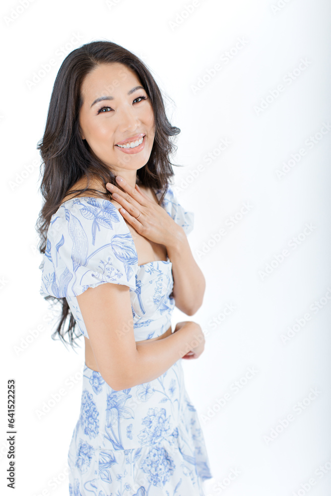 Asian young woman in summer dress against white background