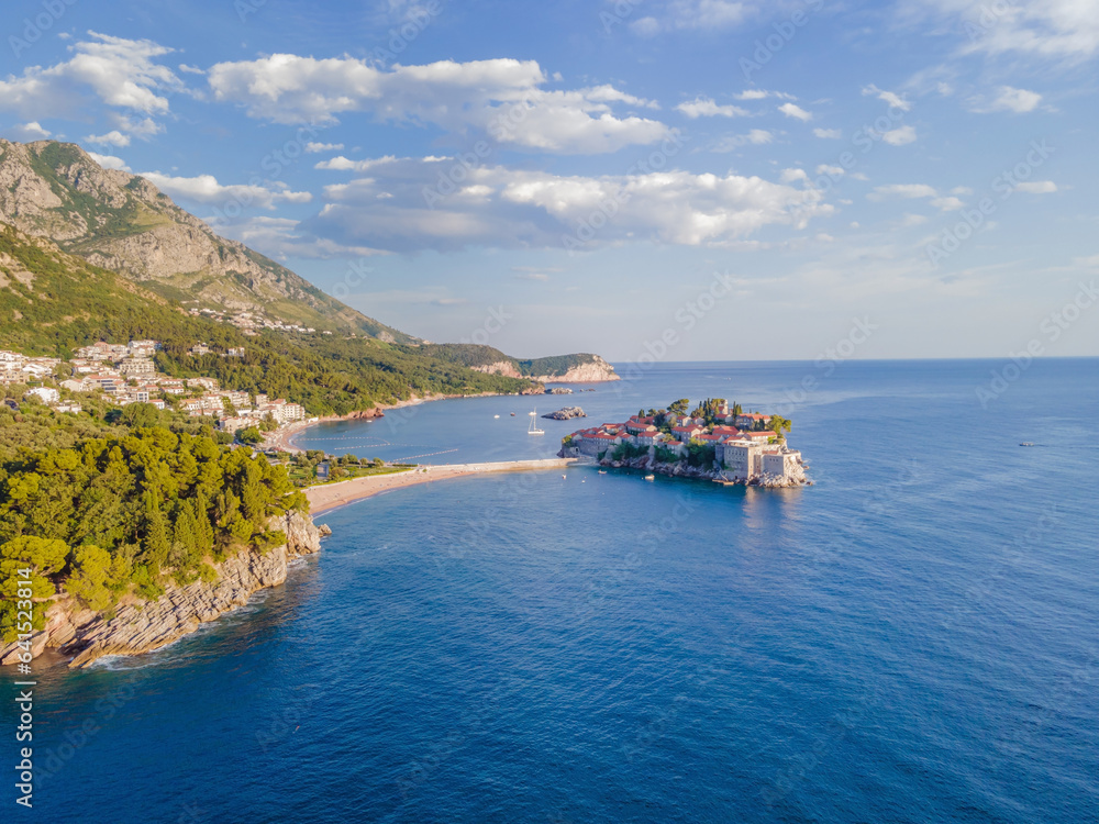 Aerophotography. Aerial view of Sveti Stefan island in a beautiful summer day, Montenegro from flying drone. Panoramic above view of Saint Stephen luxury resort. Tourism and leisure concept