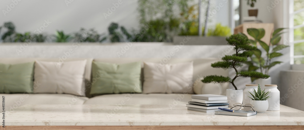 Copy space on a marble tabletop with a blurred modern cozy living room with a comfortable couch Copy space on a marble tabletop with a blurred modern cozy living room with a comfortable couch