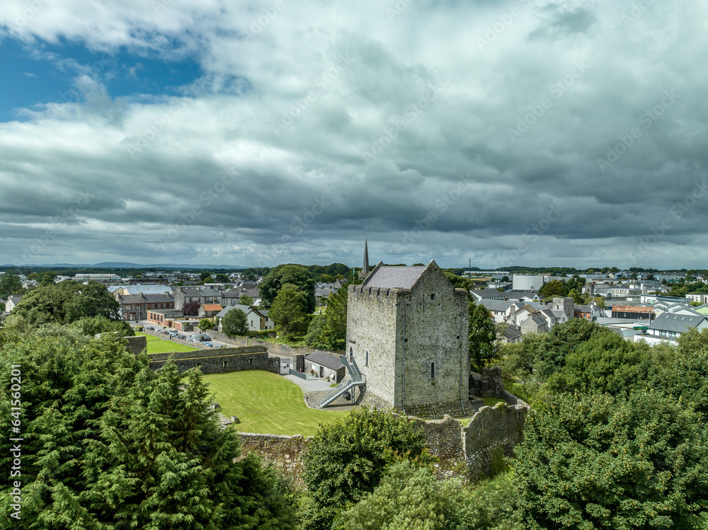 Aerial view of Athenry castle tower house dramatic three-storey hall-keep survives from the mid-thirteenth century, large, rectangular building with gabled roof and medieval walled town and priory in 