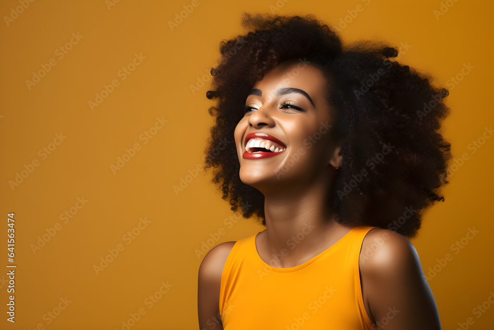portrait of black woman smiling in a studio, plain colour background portrait of black woman smiling in a studio, plain colour background