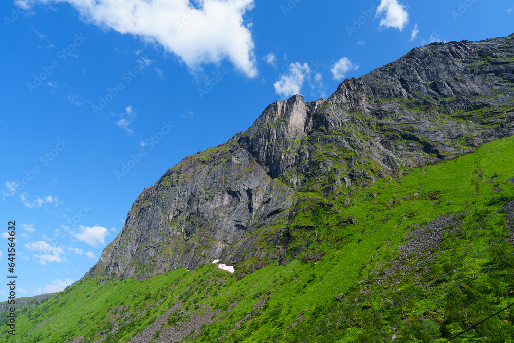 Beautiful classic Norwegian summer landscape in the month of July. mighty mountains meadows, sea. Beautiful classic summer view over the fjord. Beautiful classic Norwegian summer landscape in the month of July. mighty mountains meadows, sea. Beautiful classic summer view over the fjord.