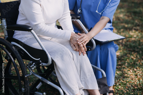 Asian young woman nurse at nursing home take care disabled senior man. Caregiver doctor serve physical therapy for older elderly patient to exercise and practice walking on walker or cane at backyard.