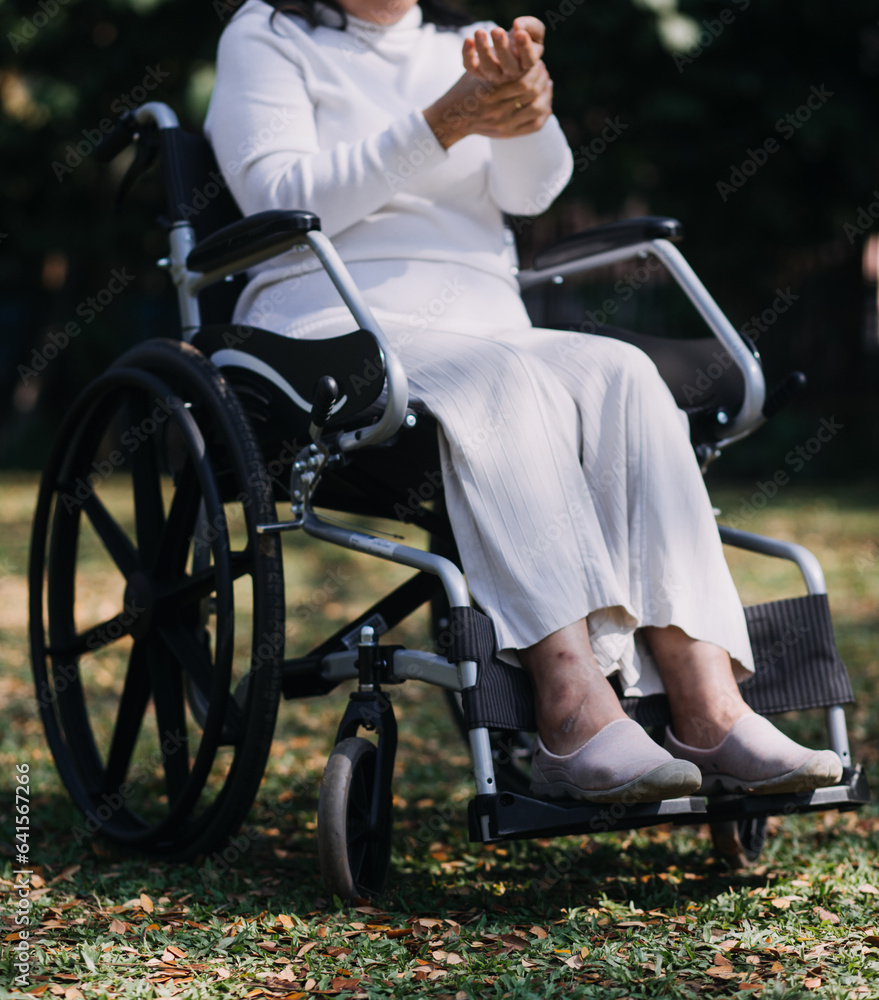 Obraz premium Asian young woman nurse at nursing home take care disabled senior man. Caregiver doctor serve physical therapy for older elderly patient to exercise and practice walking on walker or cane at backyard.