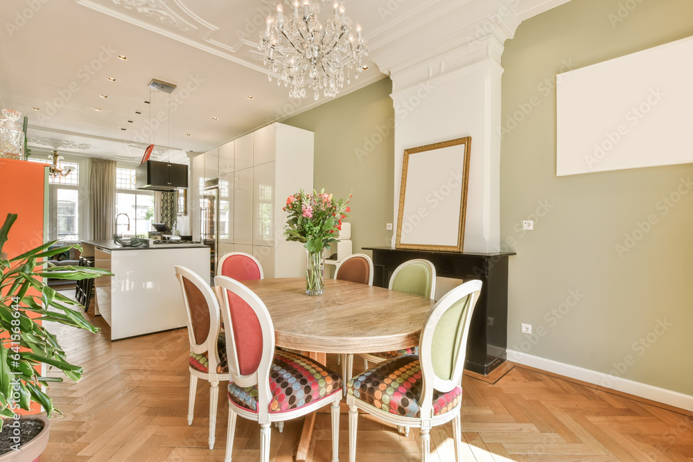 a dining room with wood flooring and white trim on the walls there is a chandel in the center of the room a dining room with wood flooring and white trim on the walls there is a chandel in the center of the room