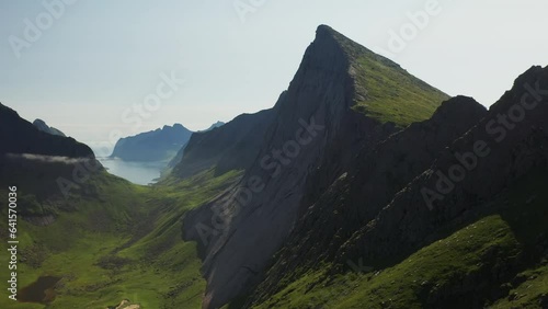 Cinematic rising drone shot of cliffs at Horseid Beach.  Northern side of Moskenesøy, in the western part of Lofoten photo