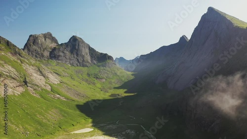 Cinematic drone shot of Horseid Beach with turquoise blue water, clouds moving over cliffs. Northern side of Moskenesøy, in the western part of Lofoten photo