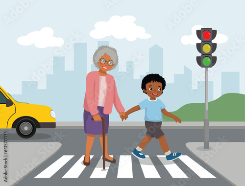 Little African boy help elderly grandmother crossing street at the pedestrian traffic