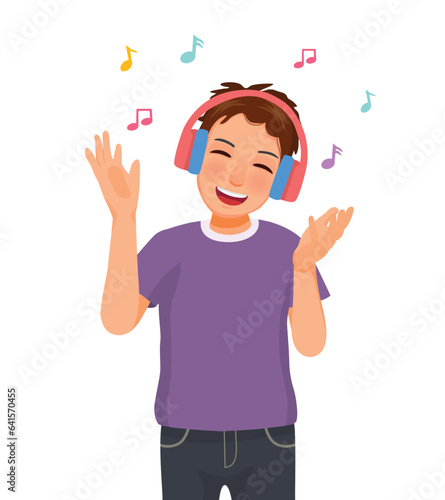 Happy young man listening to music using headphone singing with hand expressions