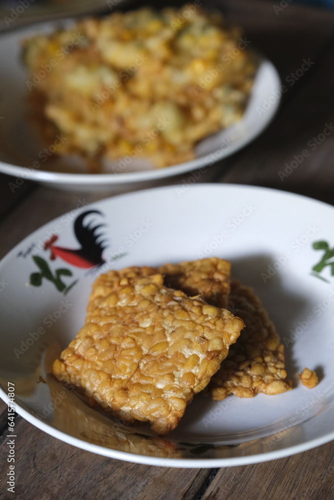 Fried tempeh on plate. Tempe goreng Fried tempeh on plate. Tempe goreng