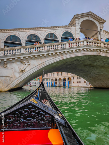 Ponte di Rialto bridge in Venice, Italy. First person view from a traditional Venetian gondola, flat-bottomed Venetian rowing boat