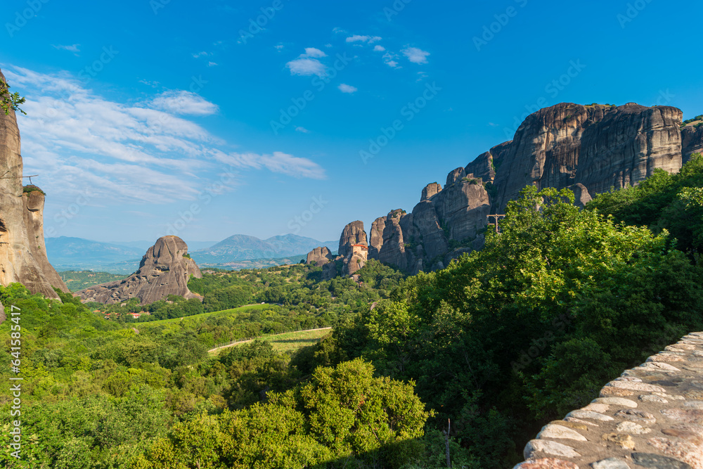 View of the natural landmark Rocks of Mount Meteora with a monastery at the top. Landscape of the Thessaly Plain, Greece.
