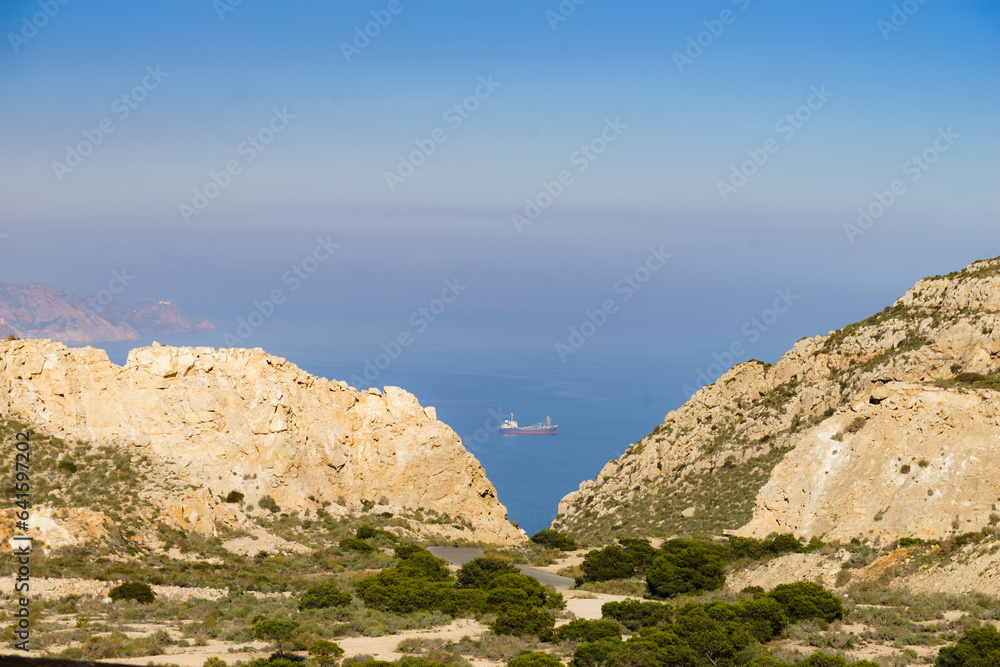Rocky coast Landscape with ship on sea, Spain