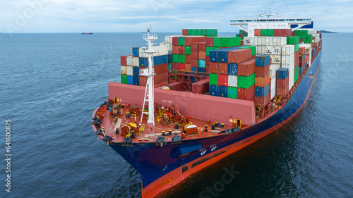 Aerial side view of cargo container ship carrying container from custom container depot go to ocean concept freight shipping by ship service on blue sky .Freight Forwarding Service