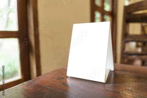 Wallpaper Mural Menu mock up blank for text marketing promotion. Mock up Menu frame standing on wood table in restaurant space for text Torontodigital.ca