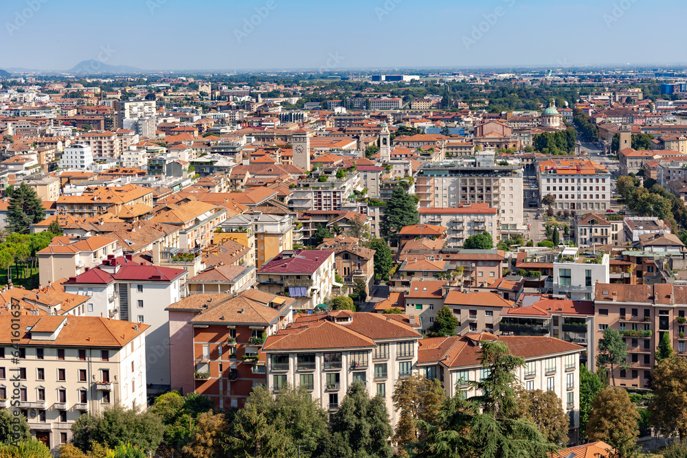 Aerial view of the old town Bergamo in northern Italy with red tiled roofs of houses on the background of the Alpine mountains. Bergamo is a city in the alpine Lombardy region.