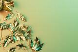 Metallic gold autumn leaves with copy space on green background