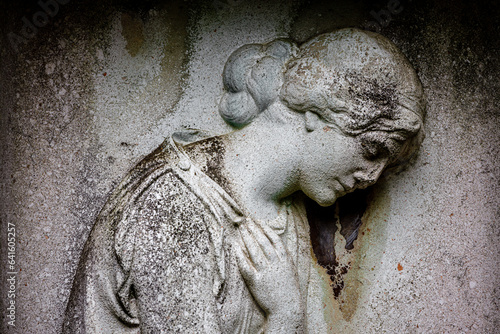 Photography ancient tombstone with the relief of an angel at a cemetery in germany
