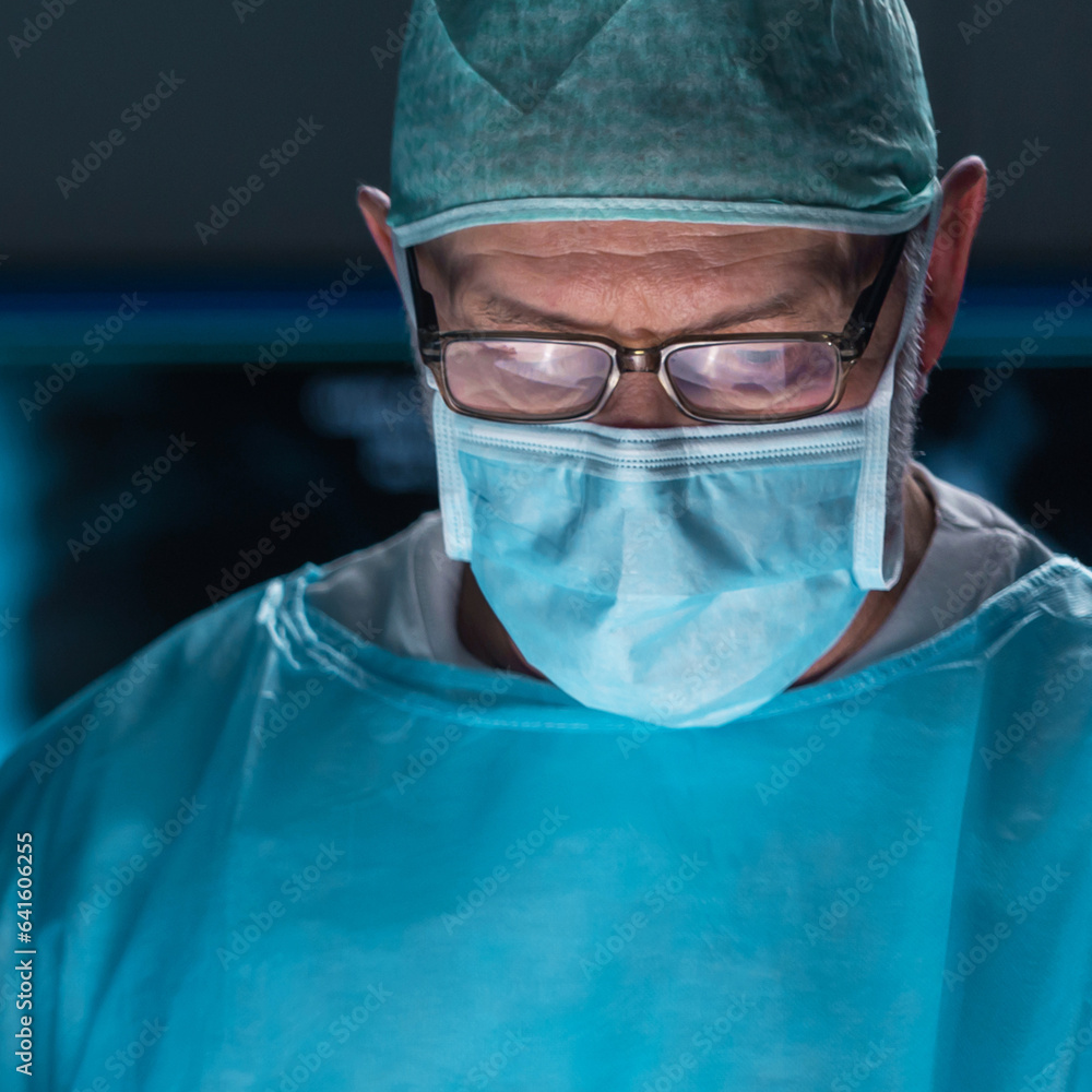 Team of medical doctors performs surgical operation in modern operating room using high-tech technology. Surgeons are working to save the patient in the hospital. Medicine, health and science. Team of medical doctors performs surgical operation in modern operating room using high-tech technology. Surgeons are working to save the patient in the hospital. Medicine, health and science.