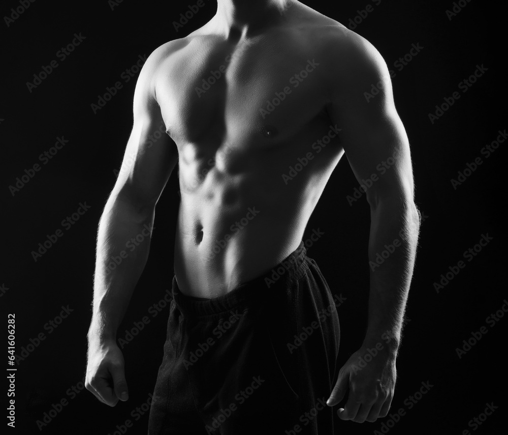Strong, fit and sporty bodybuilder man over black background Strong, fit and sporty bodybuilder man over black background