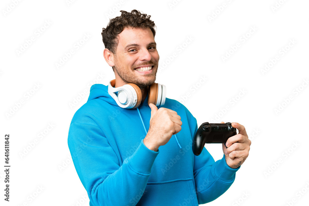 Brazilian man playing with a video game controller over isolated chroma key background proud and self-satisfied Brazilian man playing with a video game controller over isolated chroma key background proud and self-satisfied