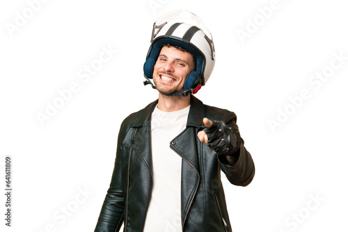 Brazilian man with a motorcycle helmet over isolated chroma key background pointing front with happy expression