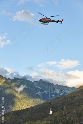 Helicopter rescue training simulation in a mountain range wood. Firefighter