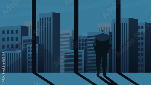 A businessman is looking at the surrounding skyscrapers from inside the building.