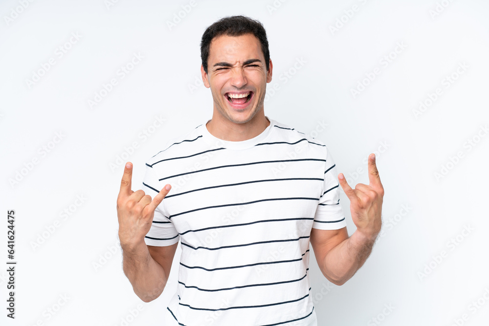 Young caucasian man isolated on white background making horn gesture Young caucasian man isolated on white background making horn gesture