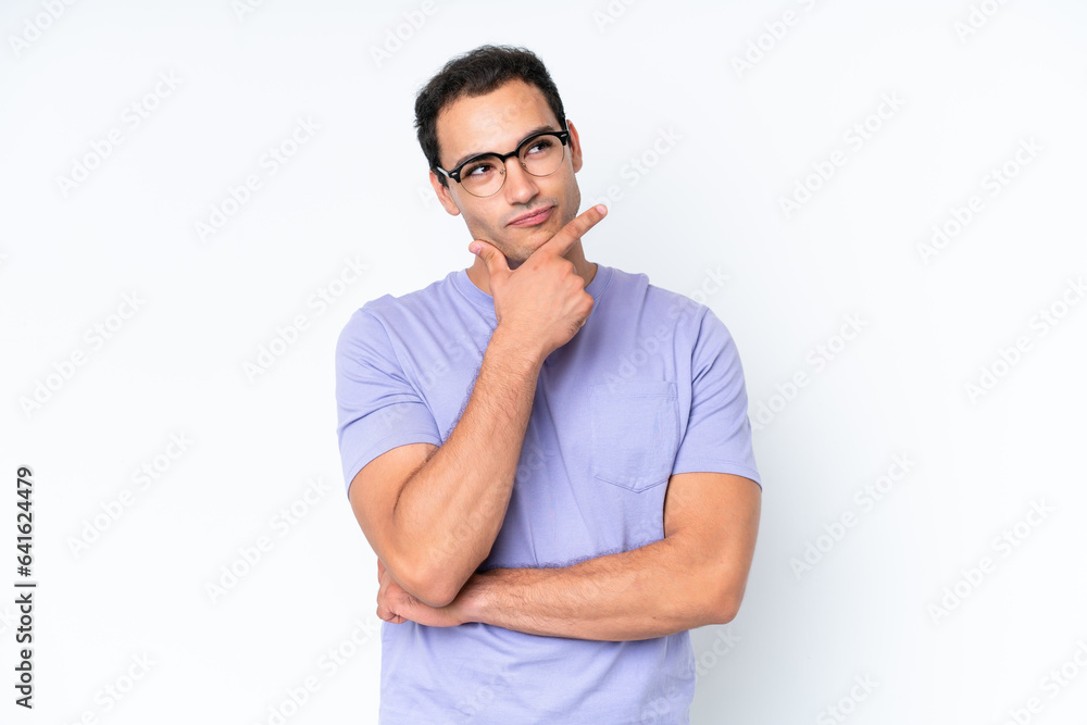 Fototapeta premium Young caucasian man isolated on white background thinking an idea while looking up
