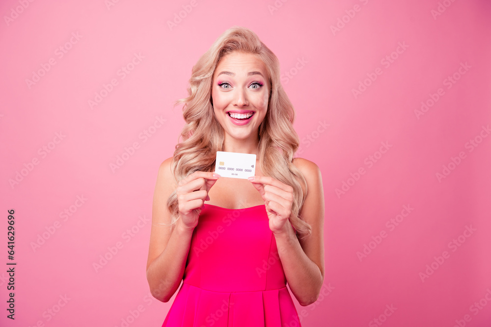 Photo of surprised positive lady wavy hairdo wear trendy clothes show bank plastic card cashless payment isolated on pink color background Photo of surprised positive lady wavy hairdo wear trendy clothes show bank plastic card cashless payment isolated on pink color background
