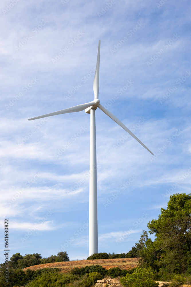 Single wind turbine tower in an eolic park in Spain. Windmills power and renewable energy. Single wind turbine tower in an eolic park in Spain. Windmills power and renewable energy.