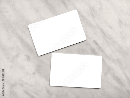Double-sided business card template with rounded edges on a gray marble background. Business card mockup. Two white or transparent frames with copy space