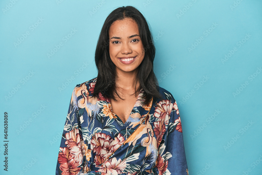 Joyful Filipina in traditional kimono posing on blue studio backdrop Joyful Filipina in traditional kimono posing on blue studio backdrop