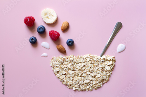 Bowl made of oat flakes with fruit and nuts falling inside, healthy breakfast concept creative