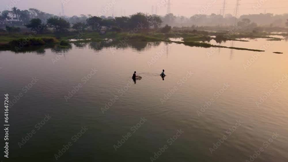 Fisher man Fisher woman catching for prawn with traditional fishing nets during beautiful sunrise. Fishing in pond for shrimp or javla at dawn. traditional Indian fishing in pond. Sustainable fishing Fisher man Fisher woman catching for prawn with traditional fishing nets during beautiful sunrise. Fishing in pond for shrimp or javla at dawn. traditional Indian fishing in pond. Sustainable fishing