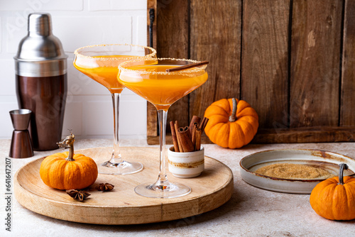 Halloween, Thanksgiving or fall cocktail pumpkin martini, homemade festive seasonal drink pumpkintini with cinnamon