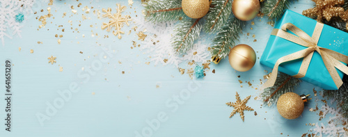 christmas card with a gift wrapped in turquoise paper with golden Christmas decorations and fir branches with confetti on a wooden background top view, legal AI