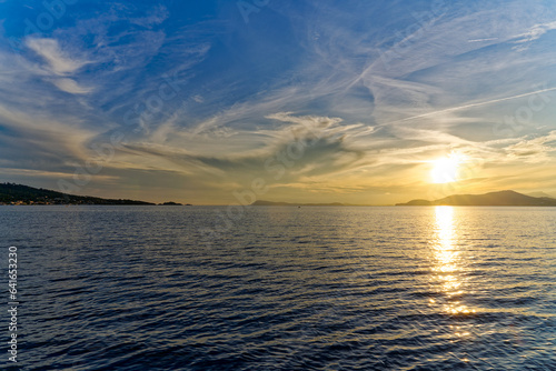 Beautiful sunset with colorful sky on a blue cloudy late spring evening at sandy beach of Giens Peninsula. Photo taken June 8th  2023  Giens  Hy  res  France.